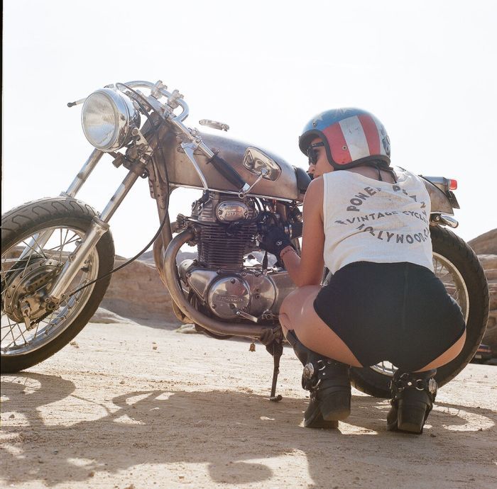 A playful frame from Girls on a motorcycle — online in Baghdad